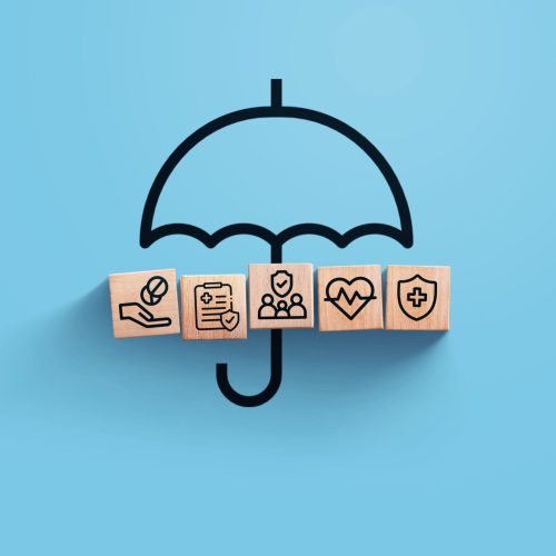 insurance, creative idea. Wooden blocks with icons of medical insurance with umbrella on blue background, top view. Health and insurance, concept